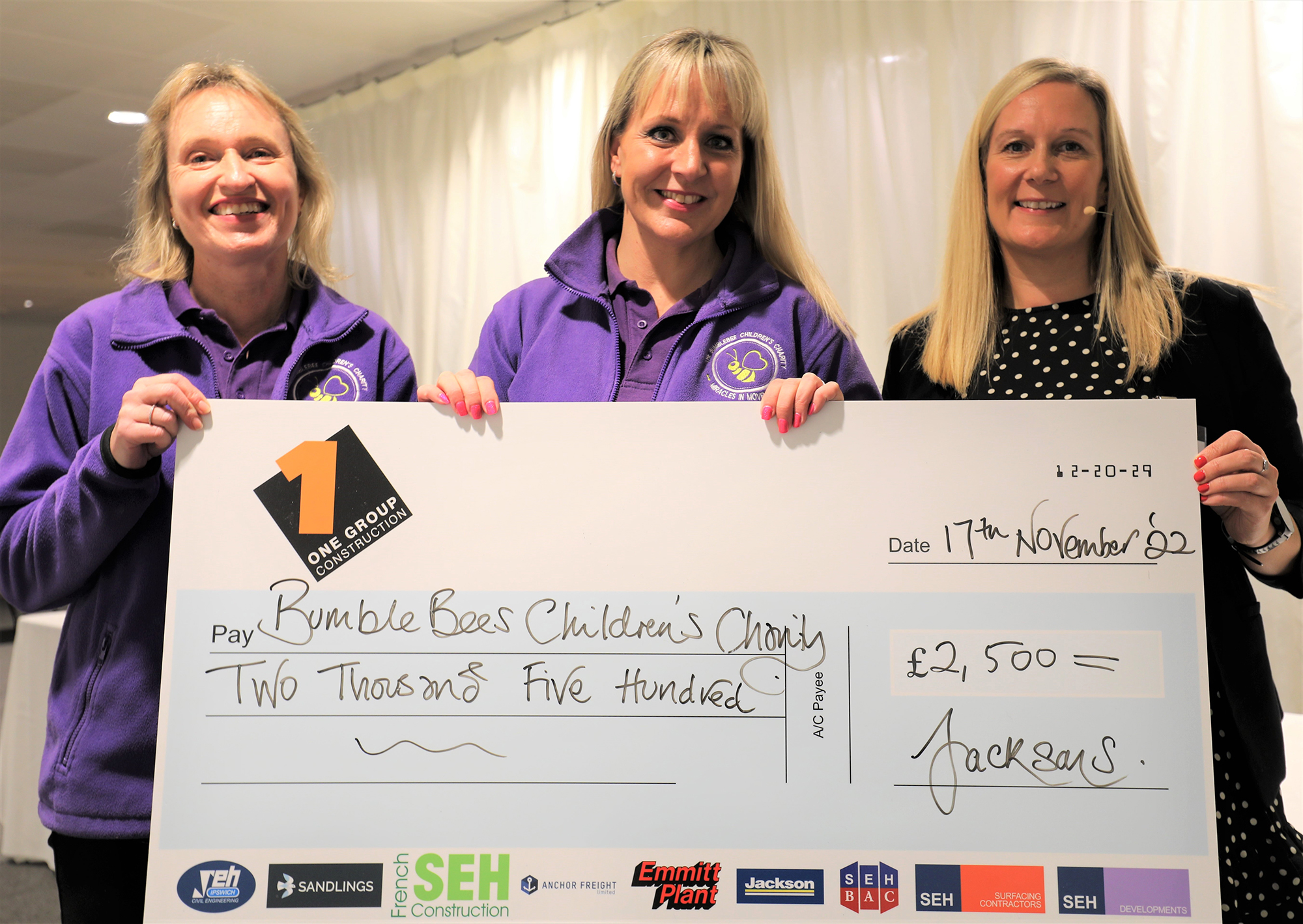 Claire Finbow (R) with presentation cheque for BumbleBees